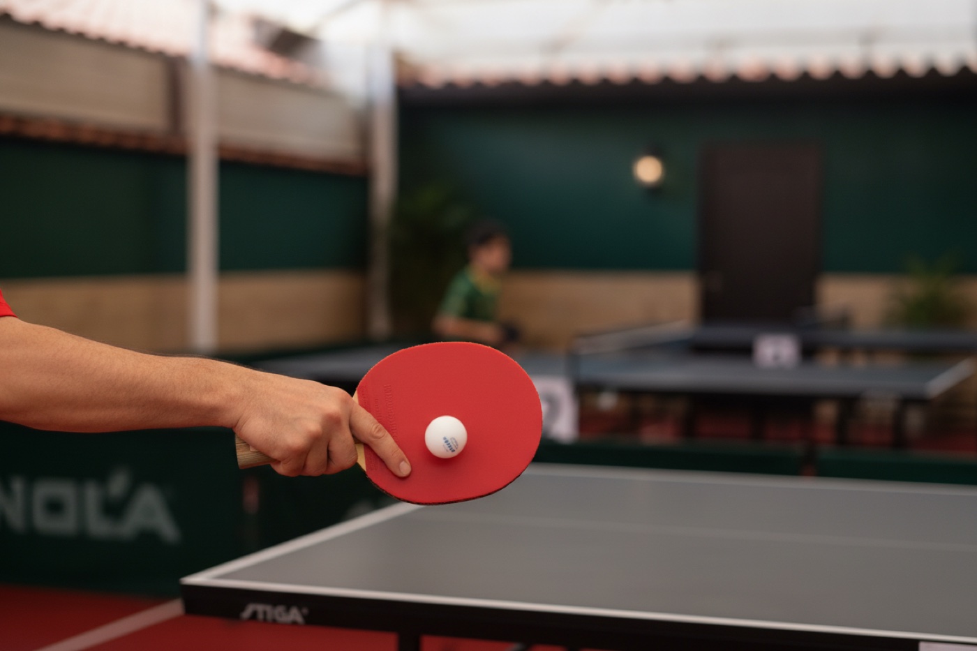 Table tennis paddle striking the ball