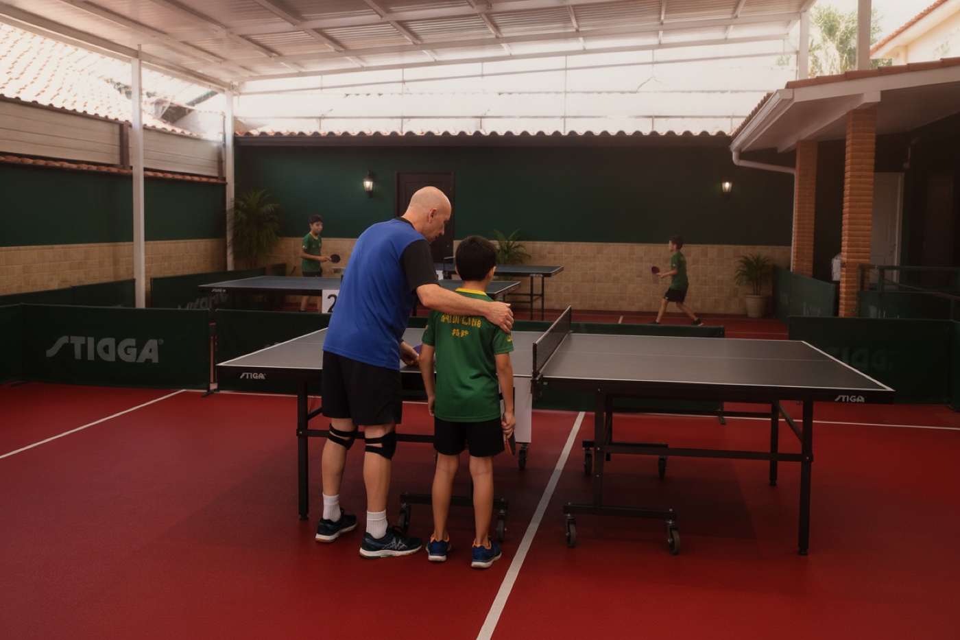 Coach guiding a young table tennis player